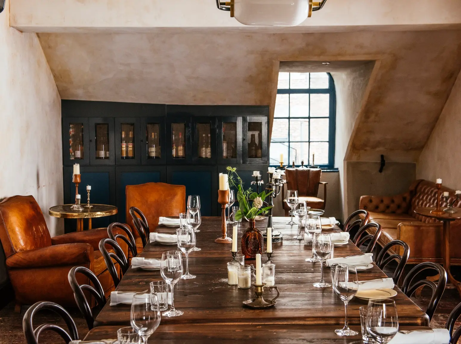 a long wooden table with chairs around it